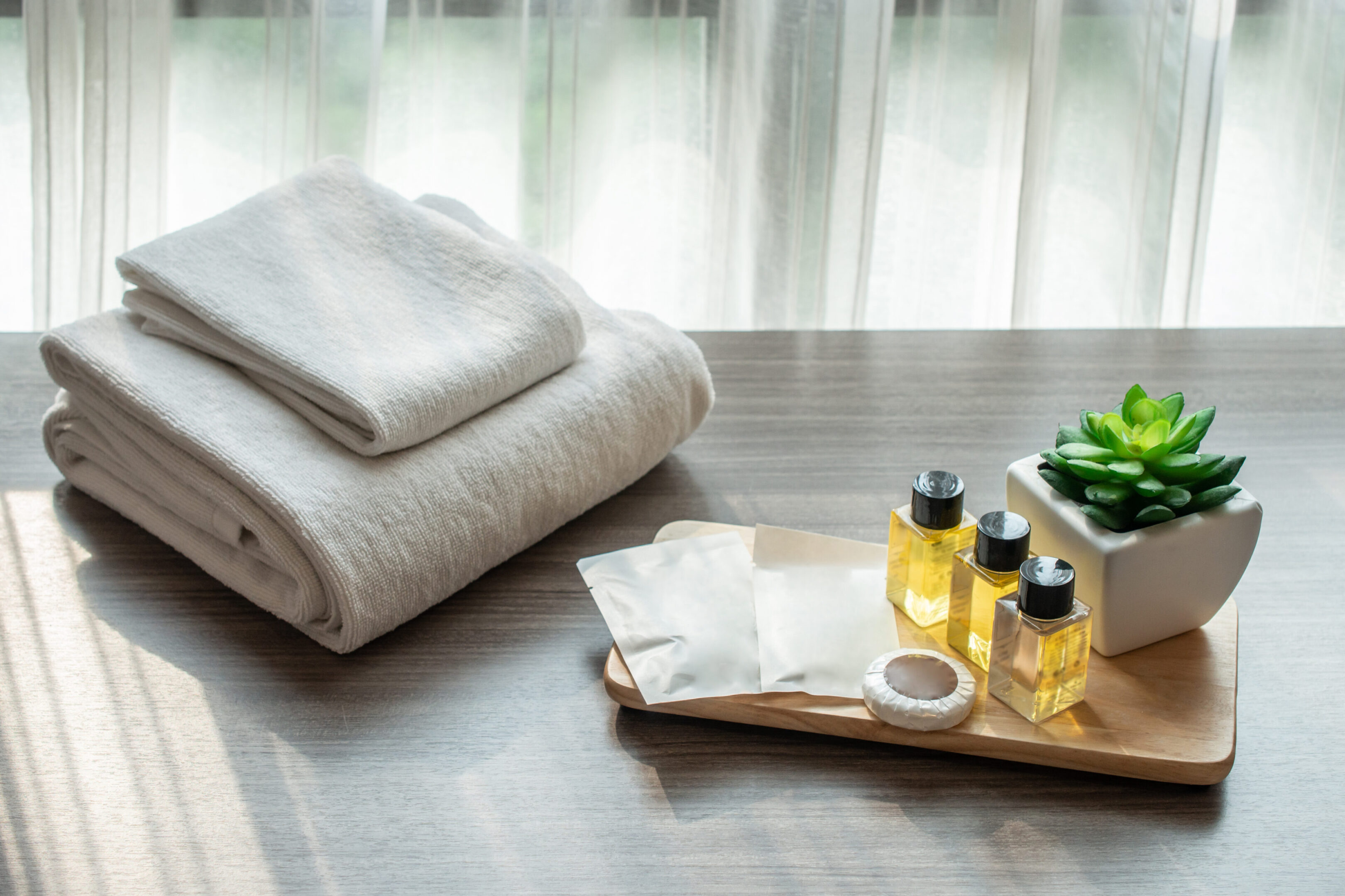 Set of hotel amenities (such as towels, shampoo, soap etc) on th