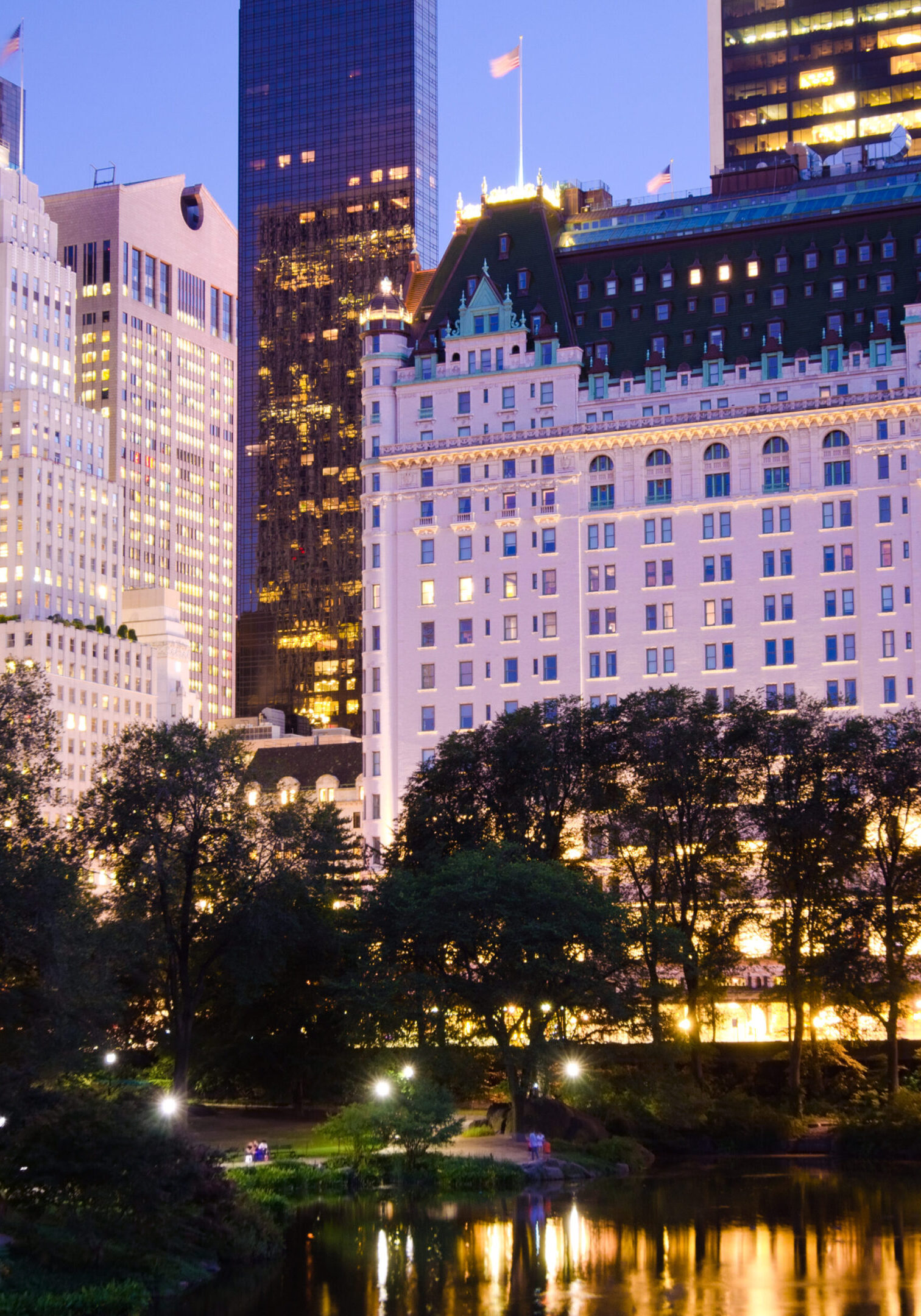 Plaza Hotel and other buildings as seen from Central Park at night in New York City.